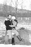 image of couple sitting on haybale