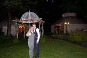 image of wedding party under umbrella