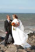 image of loving couple in wind by coast