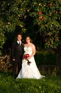 image of bride and groom under apple tree